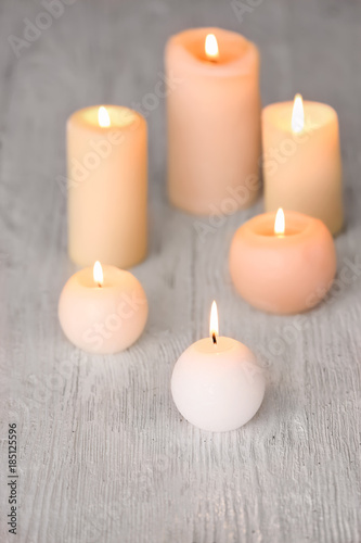 Burning candles on wooden table