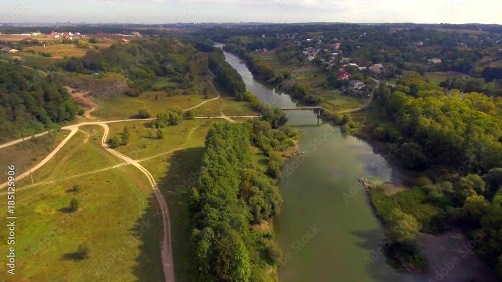 Aerial view of a beautiful landscape of typical village, river and clouds. Aerial view of a beautiful landscape of typical village, river and clouds.