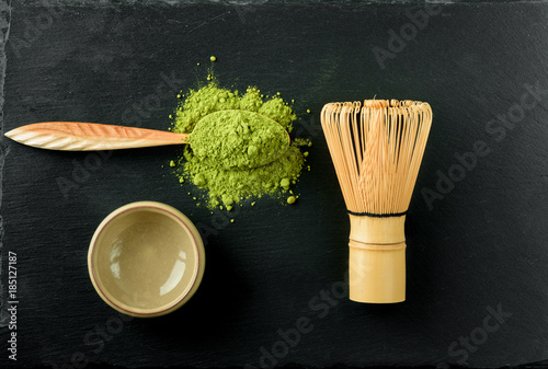 Set for Japanese green tea matcha on a black stone background. photo