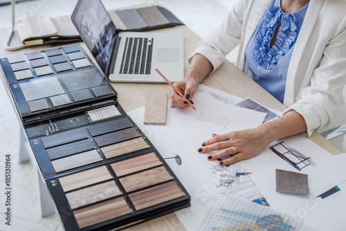 Hands of unrecognisable woman furniture designer drawing a sketch at her office.