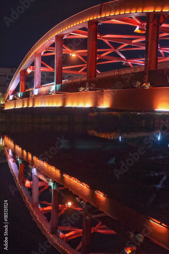 Red Iron bridge with reflection at night. photo
