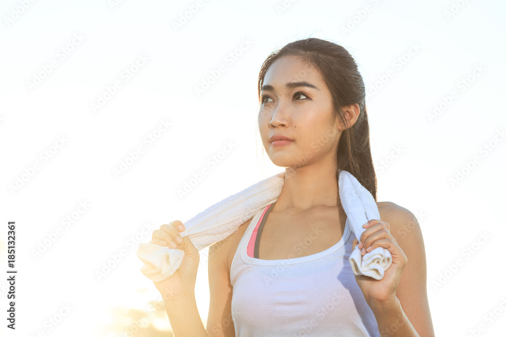 A women is  exercising and relaxing at the park.