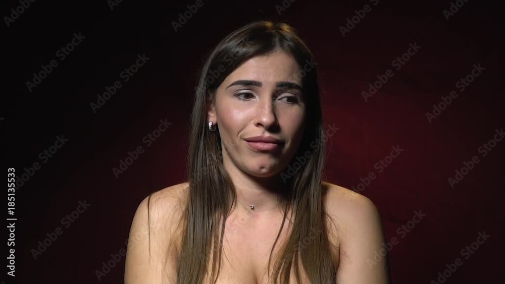 An arrogant brunette with a piercing in her nose feels a disdainful surprise, slow motion An arrogant brunette with a piercing in her nose feels a disdainful surprise, slow motion