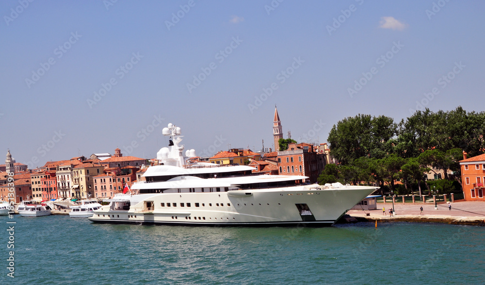 panoramic view of Venice from the height of the cruise ship . close-up of rich white yacht standing at the Wharf