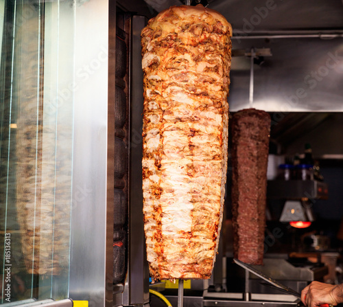 Gyro or doner roasted slowly on rotating spit. Close up view.