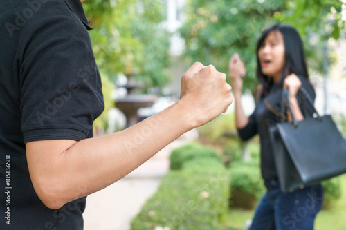 Fotografie Thief fighting and stealing handbag from screaming woman at park.