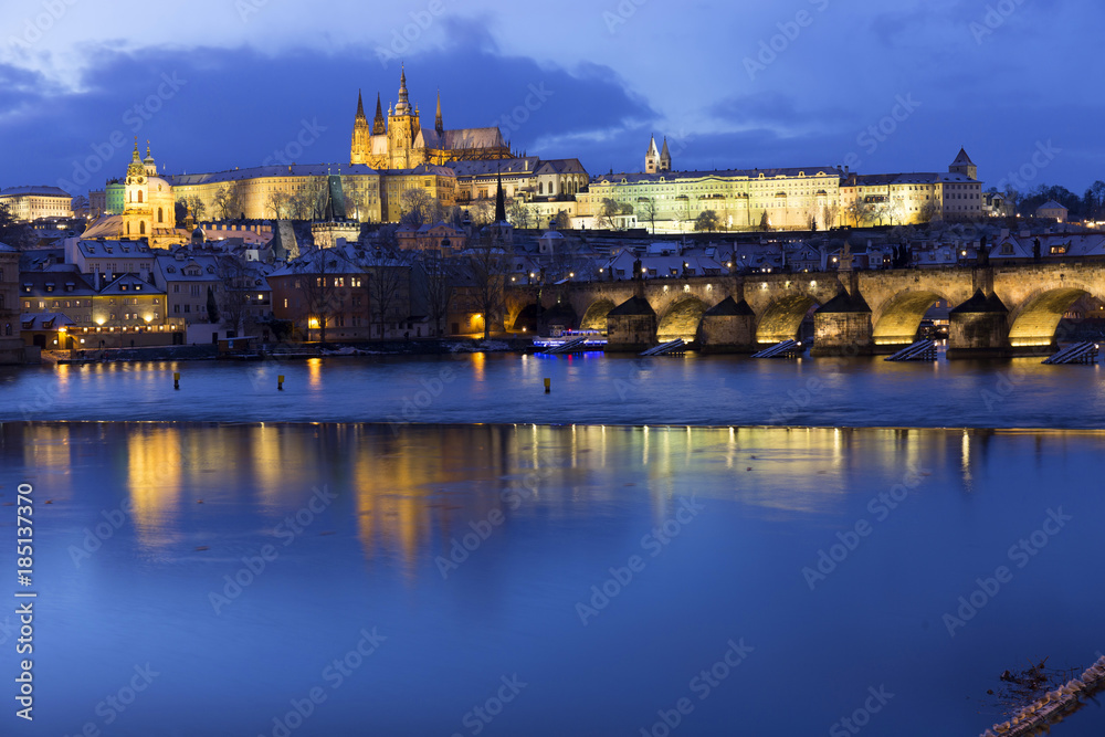 Fototapeta premium Christmas night snowy Prague Lesser Town with Charles Bridge and Prague Castle, Czech republic