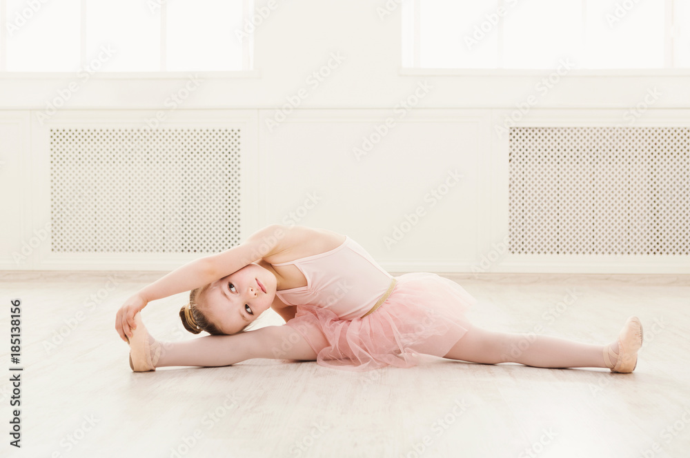 Obraz premium Portrait of little ballerina on floor, copy space