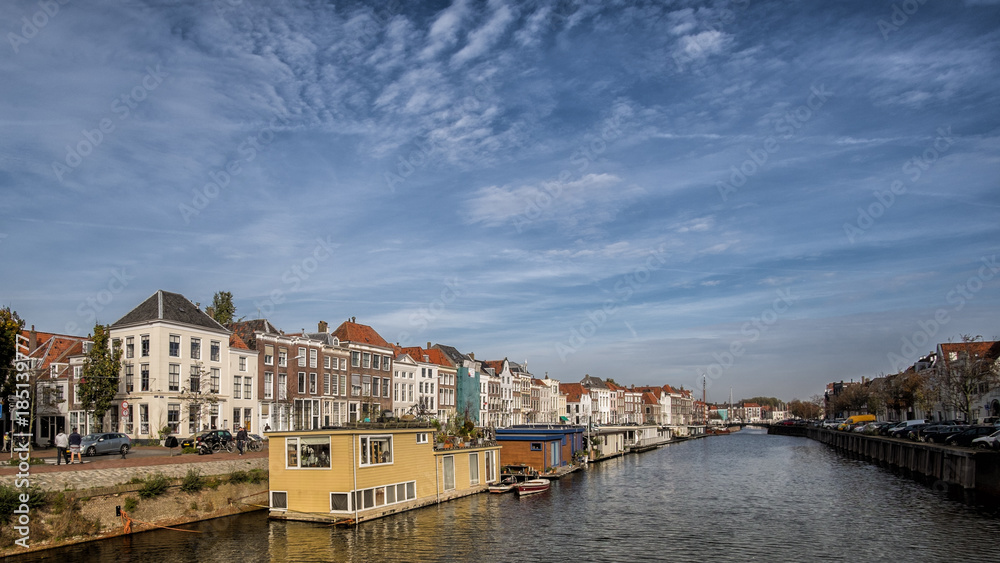 Big canal in Middelburg with houseboats and traditional dutch houses