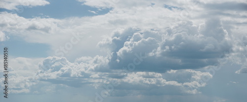 cloudscape. white cumulus clouds on a light blue sky background © Konstantin