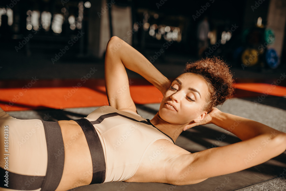 Slim sporty girl doing v ups abs workout Slim sporty girl doing v ups abs workout