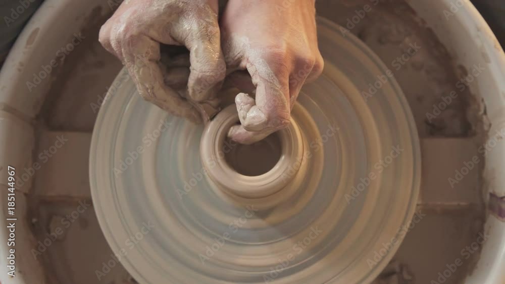 Rotating potter's wheel and clay ware on it (vase) taken from above