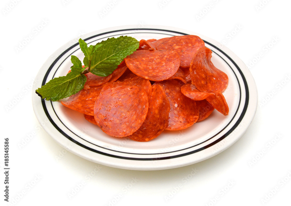 Slices of pepperoni on white background Slices of pepperoni on white background