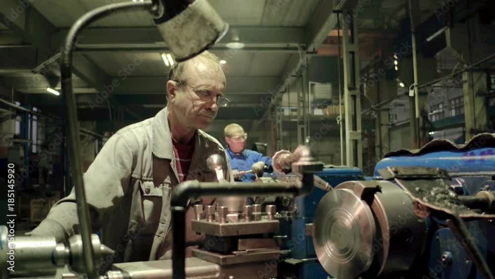 Factory employee using professional equipment for metal working detail and parts Factory employee using professional equipment for metal working detail and parts