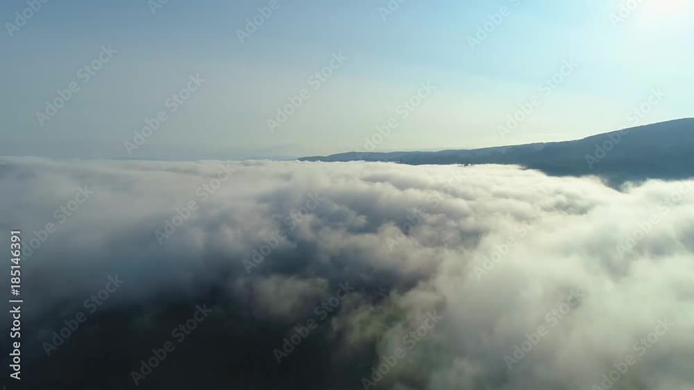 Aerial View. Flying over the high mountains in beautiful clouds . Aerial camera shot. Air clouds Aerial View. Flying over the high mountains in beautiful clouds . Aerial camera shot. Air clouds