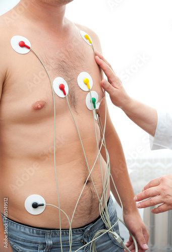 man with electrocardiographic sensors photo