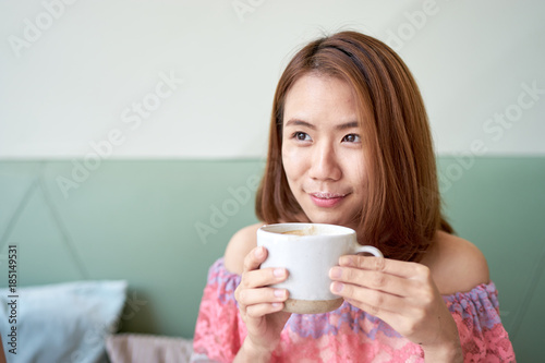 Portrait of a beautiful young asian woman drinking coffee at cafe