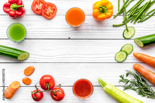 Wellness elements. Colorful detox drinks with vegetables on white wooden background top view copyspace