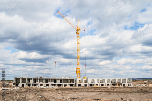 A yellow crane on blue sky. A sunny day. White Cumulus clouds © Stop war in Ukraine!