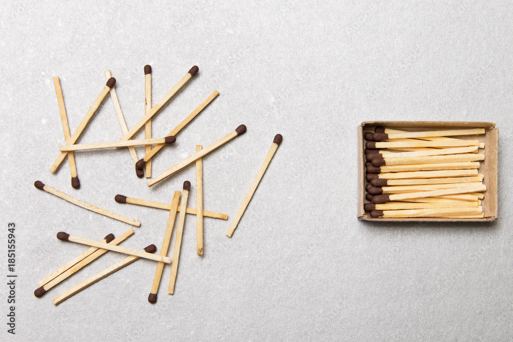 The concept of chaos and order. Chaotic match boxes lying around with the order of stacked matches