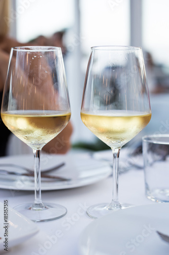 Two glass of white wine standing on the table