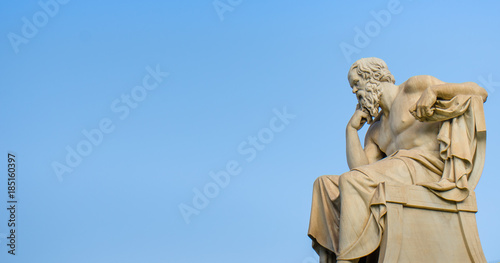 Ancient marble statue of the great Greek philosopher Socrates on background the blue sky.  photo