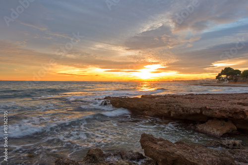 The calm sea in a very cloudy sunset