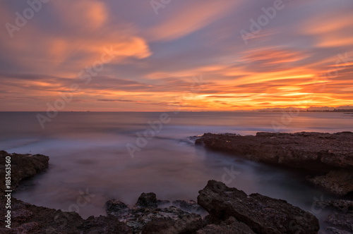 The calm sea in a very cloudy sunset © vicenfoto