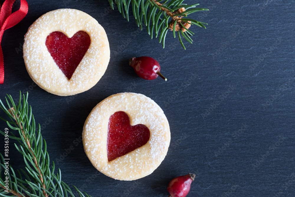Christmas background with Linzer Christmas cookies and spruce branches