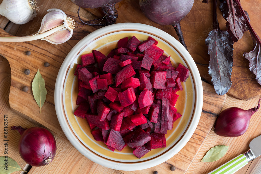 Sliced red beets on a wooden table, top view
