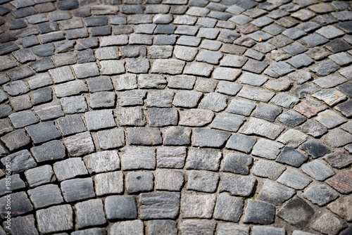 Old cobblestone road in city of Europe