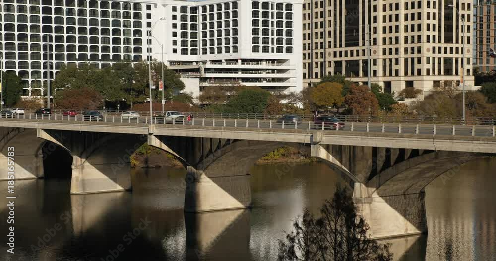 An early evening long shot of traffic flowing over the S Congress Avenue Bridge over the Colorado River in downtown Austin, Texas. An early evening long shot of traffic flowing over the S Congress Avenue Bridge over the Colorado River in downtown Austin, Texas.