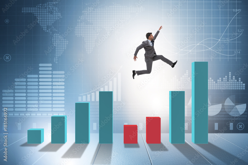 Young businessman in business concept with bar charts Young businessman in business concept with bar charts
