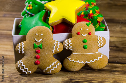 Tasty Christmas gingerbread cookies in box on wooden table