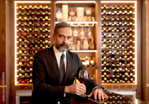 Handsome mature man tasting...
