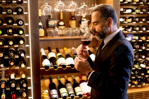 Handsome mature man tasting...