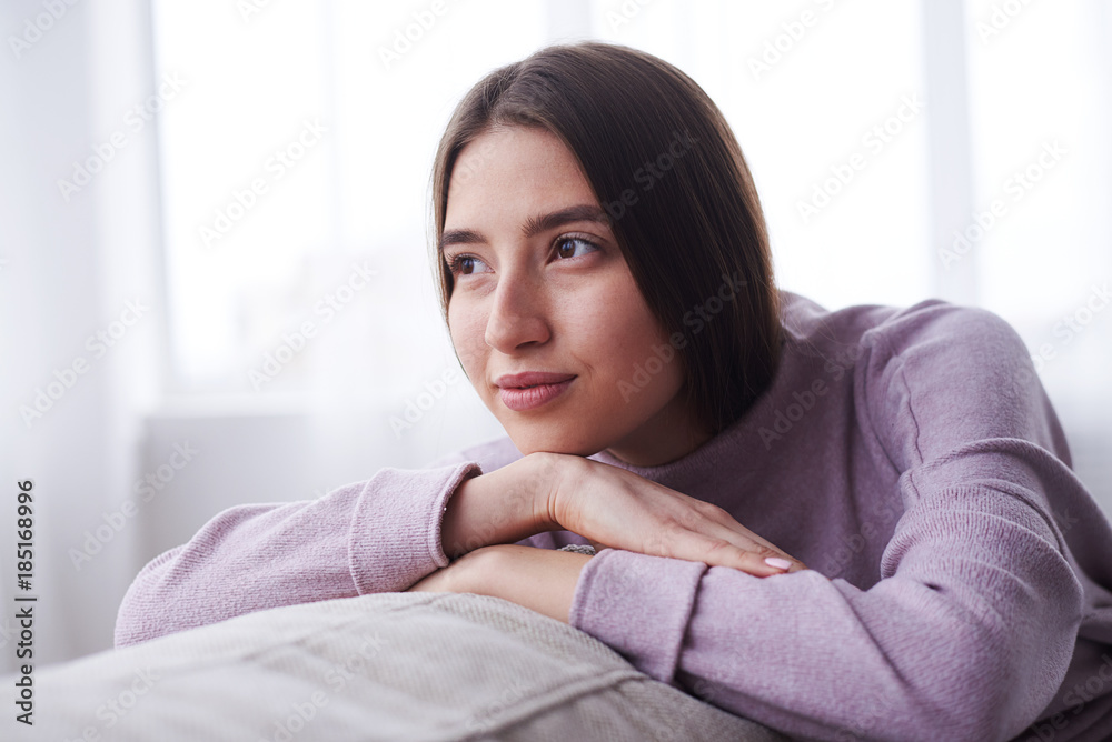 Dreamy girl relaxing on sofa at home Dreamy girl relaxing on sofa at home