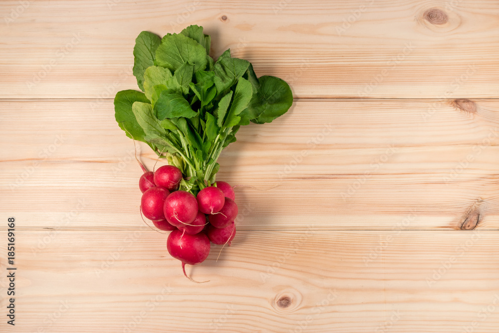 Fresh radishes on wooden background. Flat lay. Fresh radishes on wooden background. Flat lay.