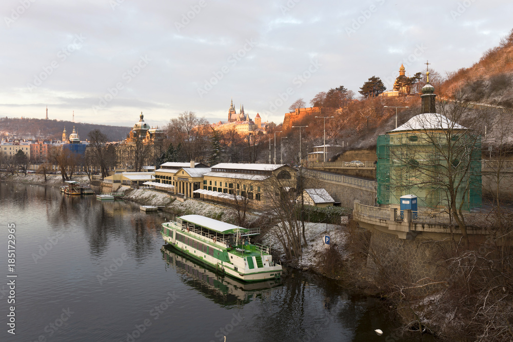 Early Morning Christmas snowy Prague Lesser Town with gothic Castle above River Vltava, Czech republic