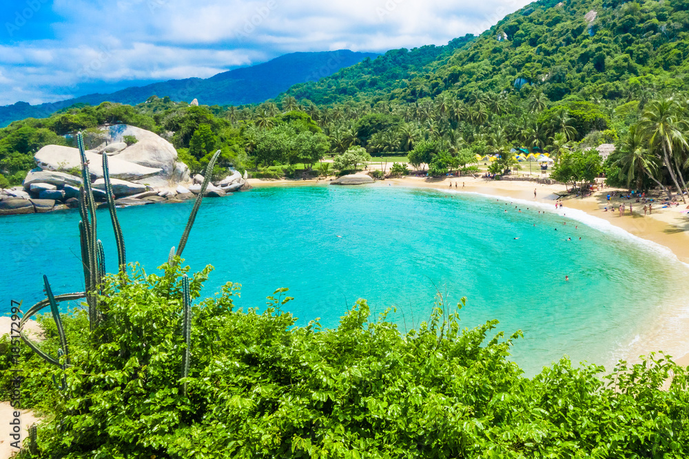 Fototapeta premium Aerial view of unidentified people enjoying the water of beach at Cabo San Juan,Tayrona Natural National Park, Colombia