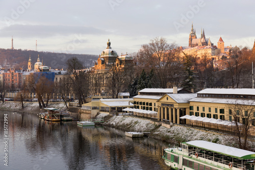Early Morning Christmas snowy Prague Lesser Town with gothic Castle above River Vltava, Czech republic
