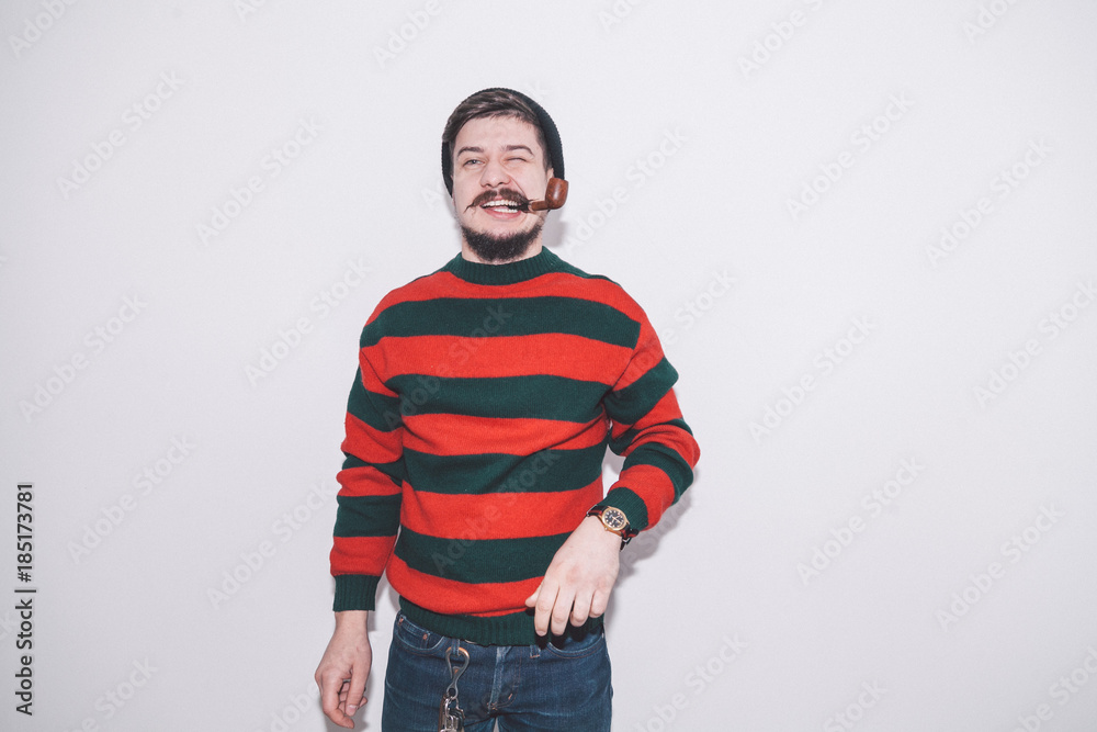 Fototapeta premium boy wearing bobble hat and smoking tobacco pipe