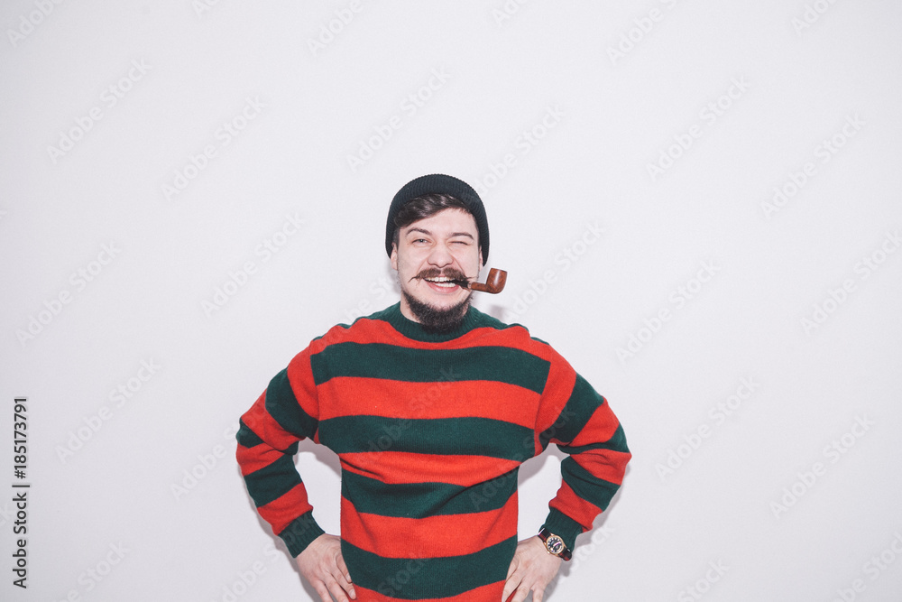 boy wearing bobble hat and smoking tobacco pipe boy wearing bobble hat and smoking tobacco pipe