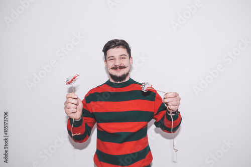 funny boy plays with christmas decoration