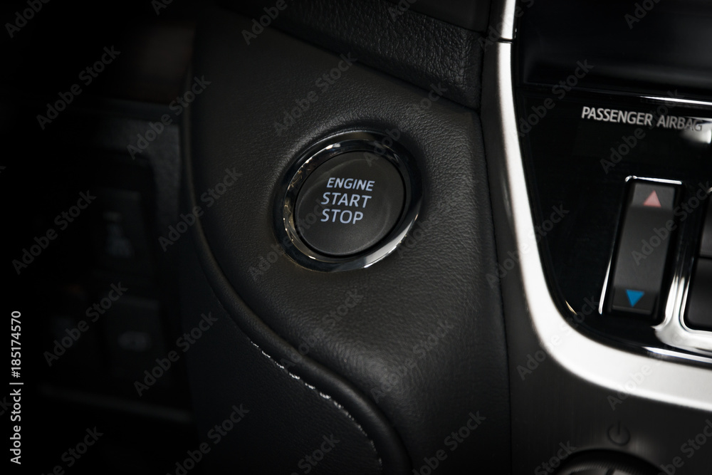 Engine start stop button in a modern luxury car interior