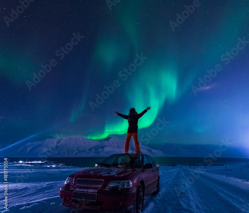 The polar arctic Northern lights aurora borealis sky star in Norway Svalbard man in Longyearbyen city the moon mountains