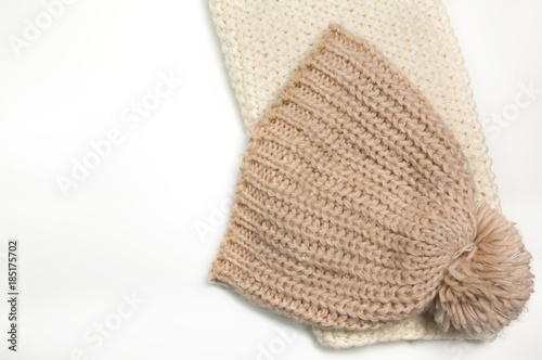 Large-knitted hat and white scarf snud on white background.Space for text