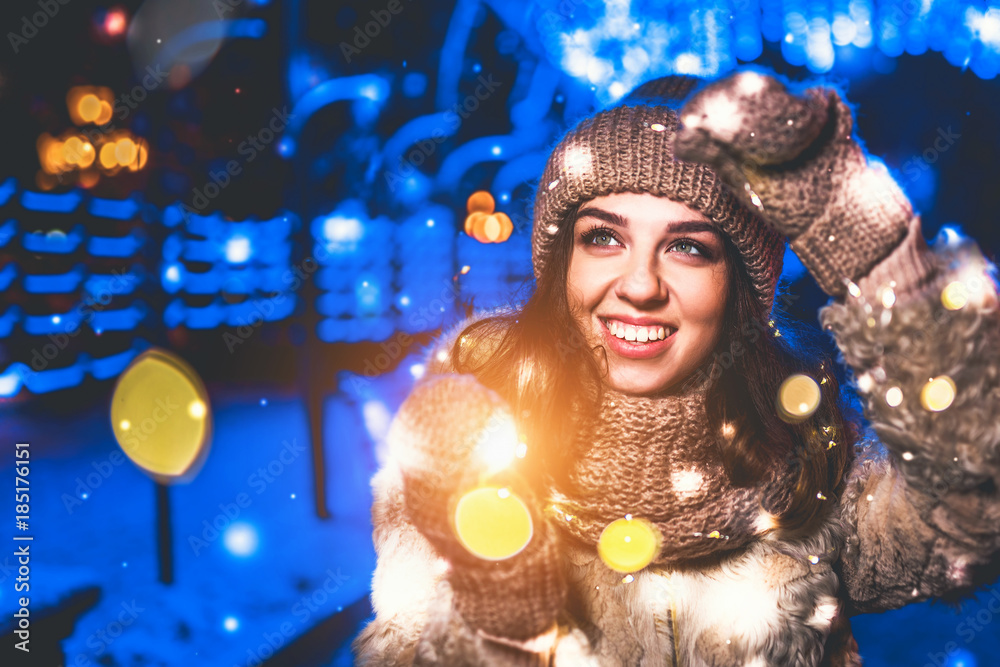 Pretty girl on the street with christmas lights around Pretty girl on the street with christmas lights around