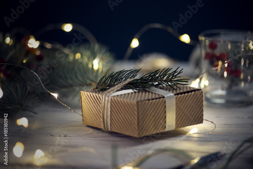 Foto Christmas gifts, knitted blanket, pine cones, fir branches