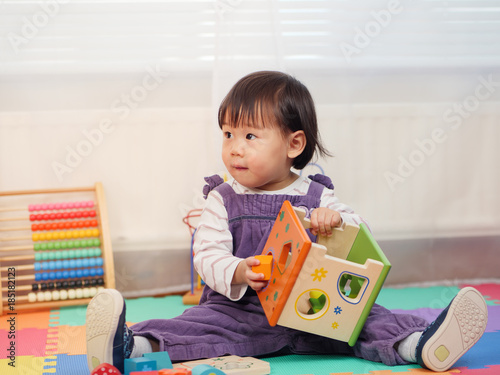 Baby girl play toy at home